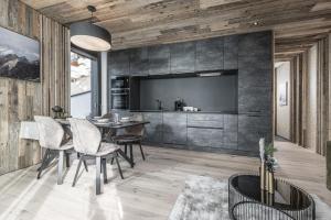 a dining room with a table and a flat screen tv at Perfect Lodgings Panorama Hart in Hart im Zillertal +18 photos