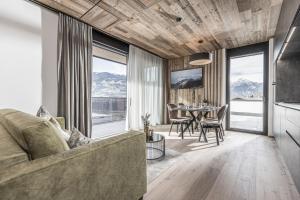 a living room with a couch and a table at Perfect Lodgings Panorama Hart in Hart im Zillertal