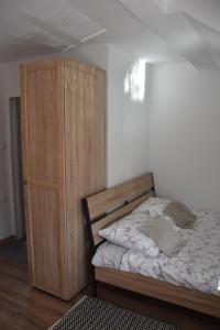 a bedroom with a bed and a wooden cabinet at Pokój w Karpaczu in Karpacz
