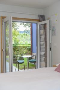 una camera da letto con porta che si apre su un patio con tavolo e sedie di Holiday Park Vile - Terme Krka a Strunjan Altre 37 foto