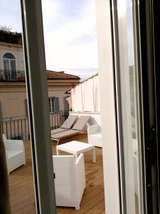 a view of a balcony with a table and chairs at Relais Luxury Corso in Rome