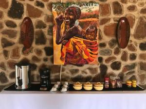 a wall with a painting of a woman holding a baby at Charming Bush chalet 6 on this world renowned Eco site 40 minutes from Vic Falls Fully catered stay - 1986 in Victoria Falls