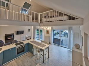 a kitchen with blue cabinets and a kitchen with a staircase at Haus Tierfreund in Hellenthal