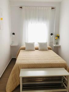 En eller flere senge i et værelse på Bonito piso céntrico con WIFI y terraza