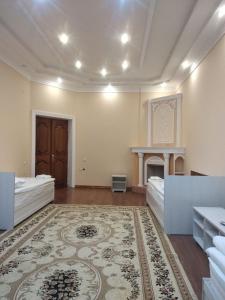 a large room with two beds and a fireplace at GUESTO HOSTEL in Tashkent