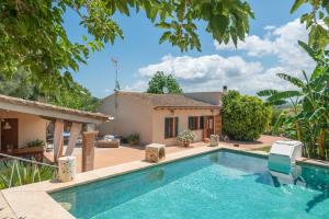 a villa with a swimming pool in front of a house at Alcudiola in Santa Margalida