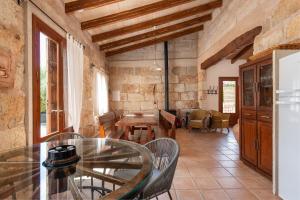 a living room with a glass table and chairs at Alcudiola in Santa Margalida