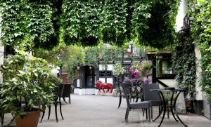 Best Western Red Lion Hotel في ساليزبري: فناء به طاولات وكراسي ونباتات