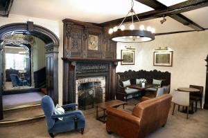 a living room with a fireplace and a table and chairs at Best Western Red Lion Hotel in Salisbury +118 photos