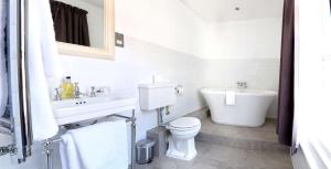 a white bathroom with a toilet and a sink at Best Western Red Lion Hotel in Salisbury