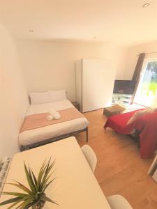 a small room with two beds and a table at Turay Court Holiday Apartments in Bournemouth