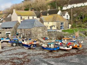 a group of boats are sitting on the ground at 1 Bed Caravan Sleeps 2 - Parking Garden Pets in Lizard
