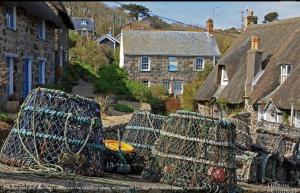 a group of houses with a chain link fence at 1 Bed Caravan Sleeps 2 - Parking Garden Pets in Lizard +21 photos
