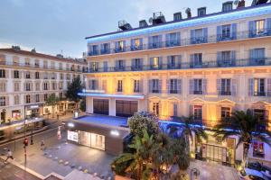 a view of a building in a city at night at Best Western Hotel Lakmi Nice in Nice