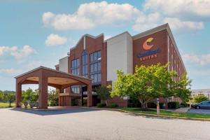 a building with a c enrollment services sign in front of it at Comfort Suites Fredericksburg South in Fredericksburg