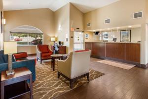 a living room with a couch and chairs and a kitchen at Comfort Inn Lehi - Thanksgiving Point Area in Lehi