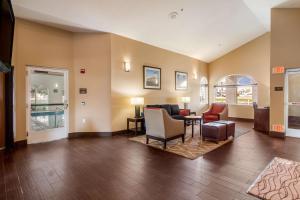 a living room with a couch and a table and chairs at Comfort Inn Lehi - Thanksgiving Point Area in Lehi