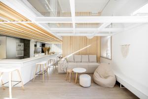 a living room with a couch and a table and chairs at White Fox - sauna - in Lviv