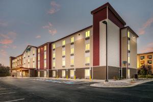 a rendering of a building with a parking lot at WoodSpring Suites Missoula in Missoula