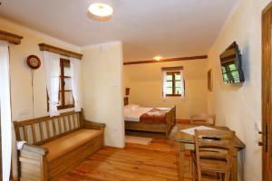 a room with two beds and a table and a desk at Pomona Relaxing Nature Guest House in Rogaška Slatina
