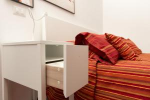 a bedroom with a bed with a white cabinet and a tv at Il Podestà in Fabriano
