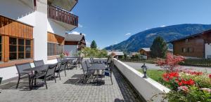 a row of chairs and tables on a patio at Catrina Hotel in Disentis