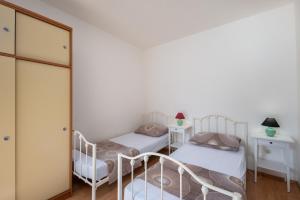 Postel nebo postele na pokoji v ubytování Apartments Lapida