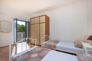 Postel nebo postele na pokoji v ubytování Apartments Lapida