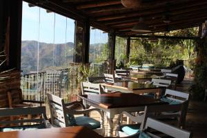 a row of tables and chairs in a restaurant at Hotel Rural Los Jarales in Istán