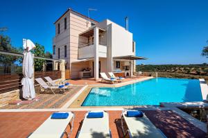 a villa with a swimming pool and a house at Margarita's Villas in Chania Town