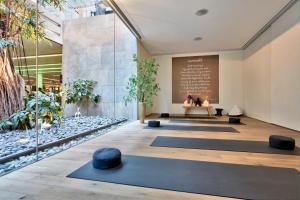 a yoga room with yoga mats in front of a chalkboard at Conservatorium Hotel in Amsterdam