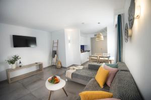 a living room with a couch and a table at Serenity Apartments in Port d'Alcudia