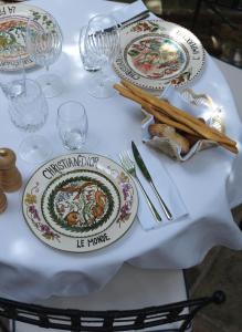 a table with plates of food on it at Hôtel Le Yaca in Saint-Tropez