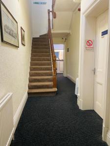 a hallway with a staircase in a building at The Roadhouse Hotel in Carlisle