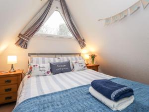 a bedroom with a bed with pillows and a window at Seashell Cottage Lodge 97 in Deal
