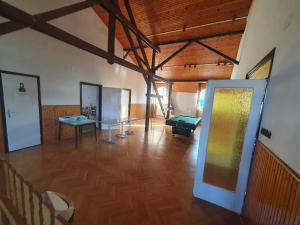 a large room with a room with a pool table at Nosztalgia Villa in Mezőkövesd