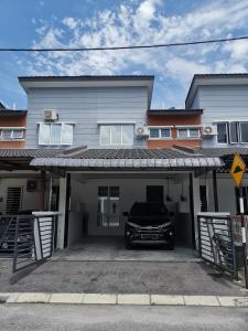a car parked in the garage of a house at LYNN HOMESTAY SERI ISKANDAR in Seri Iskandar