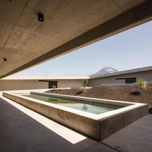 a swimming pool in the middle of a building at Azores Wine Company in Cais do Mourato