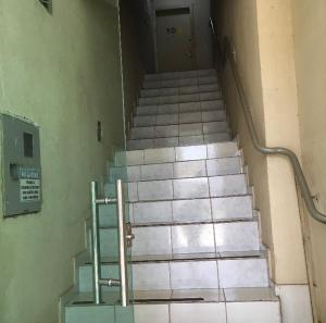 a set of stairs in a building with a door at Apartamento para temporada perto do aeroporto de Brasilia in Brasilia