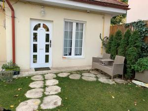 a patio with two chairs and a table in front of a house at The Hedgehog Boutique House & Garden in Cluj-Napoca