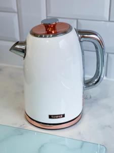 a white tea kettle sitting on a counter at Richmere Court in Wolverhampton