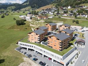 an aerial view of a building with a parking lot at Catrina Resort in Disentis