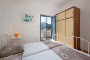 Postel nebo postele na pokoji v ubytování Apartments Lapida