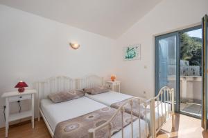 Postel nebo postele na pokoji v ubytování Apartments Lapida