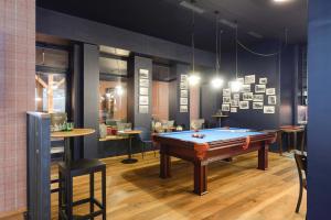 a room with a pool table and a bar at Hotel Profis in Diepoldsau