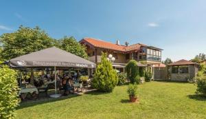 a group of people sitting in the yard of a house at Ferienwohnungen Haus am See in Bernau am Chiemsee