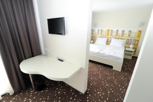 Postel nebo postele na pokoji v ubytování City Hotel Krško