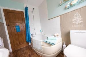 een badkamer met een bad, een toilet en een wastafel bij The Monkey House B&B in Stone +22 foto's