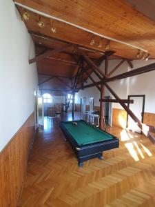 a pool table in the middle of a room at Nosztalgia Villa in Mezőkövesd