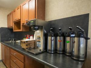 a kitchen with a counter with two water tanks at Red Roof Inn & Suites Dickinson in Dickinson